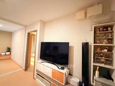 Modern living room with stylish TV setup and decorative shelving
