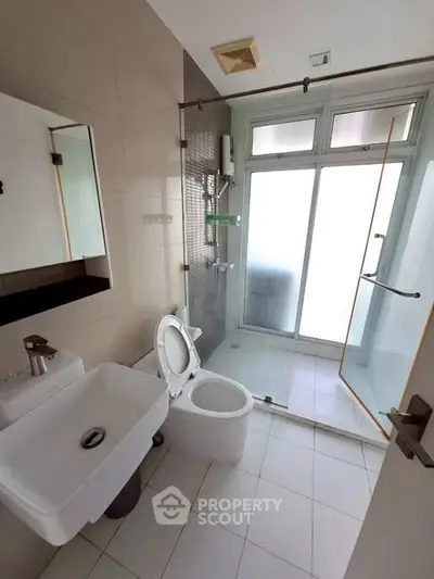 Modern bathroom with glass shower and sleek fixtures