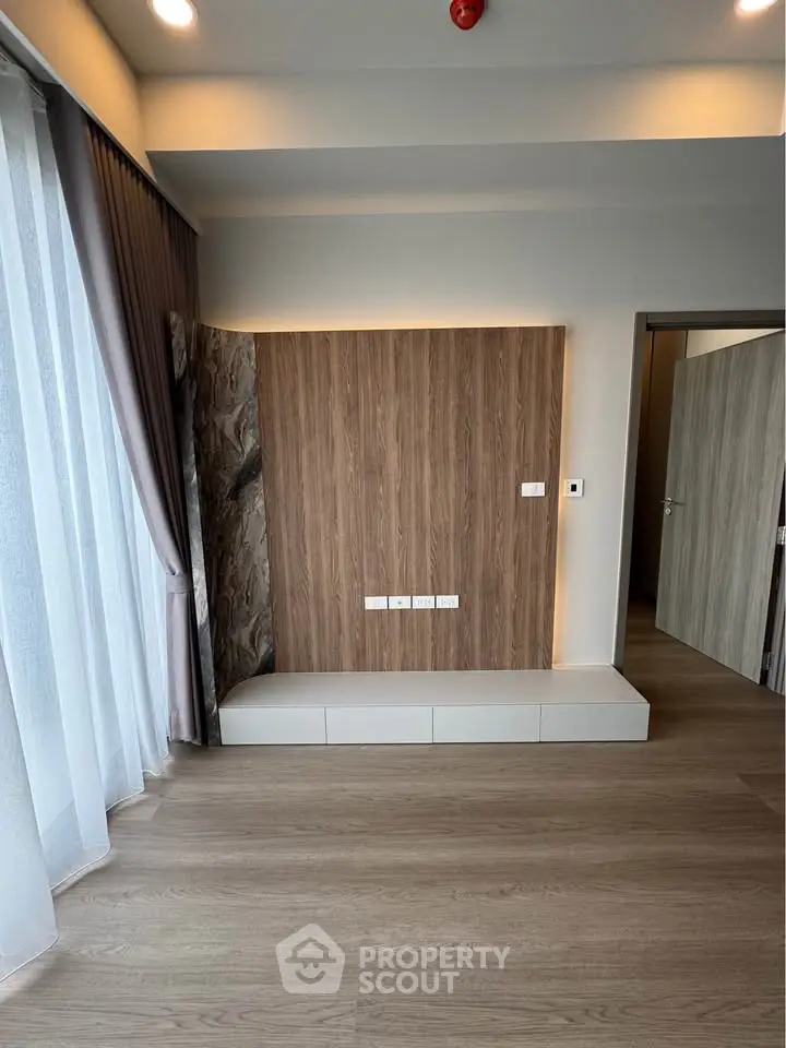 Modern minimalist living room with wood paneling and large window