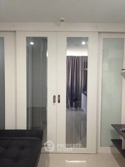 Modern interior with sliding glass doors and sleek furnishings in a stylish apartment.
