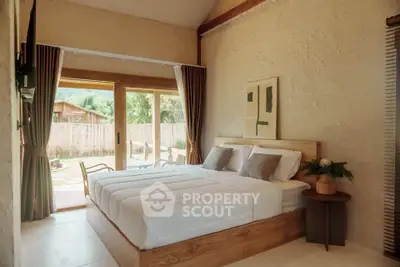 Cozy bedroom with large windows opening to a scenic view, featuring a comfortable bed and stylish decor.