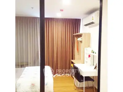 Cozy bedroom with study area and modern decor in a stylish apartment.