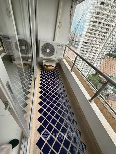 Charming balcony with city view and modern air conditioning unit, perfect for relaxation.