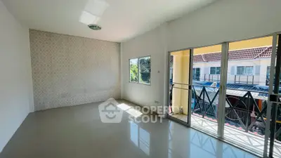 Spacious living room with large windows and balcony access in modern home