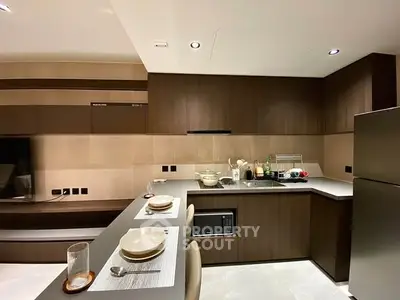 Modern kitchen with sleek cabinetry and integrated appliances in a stylish apartment.