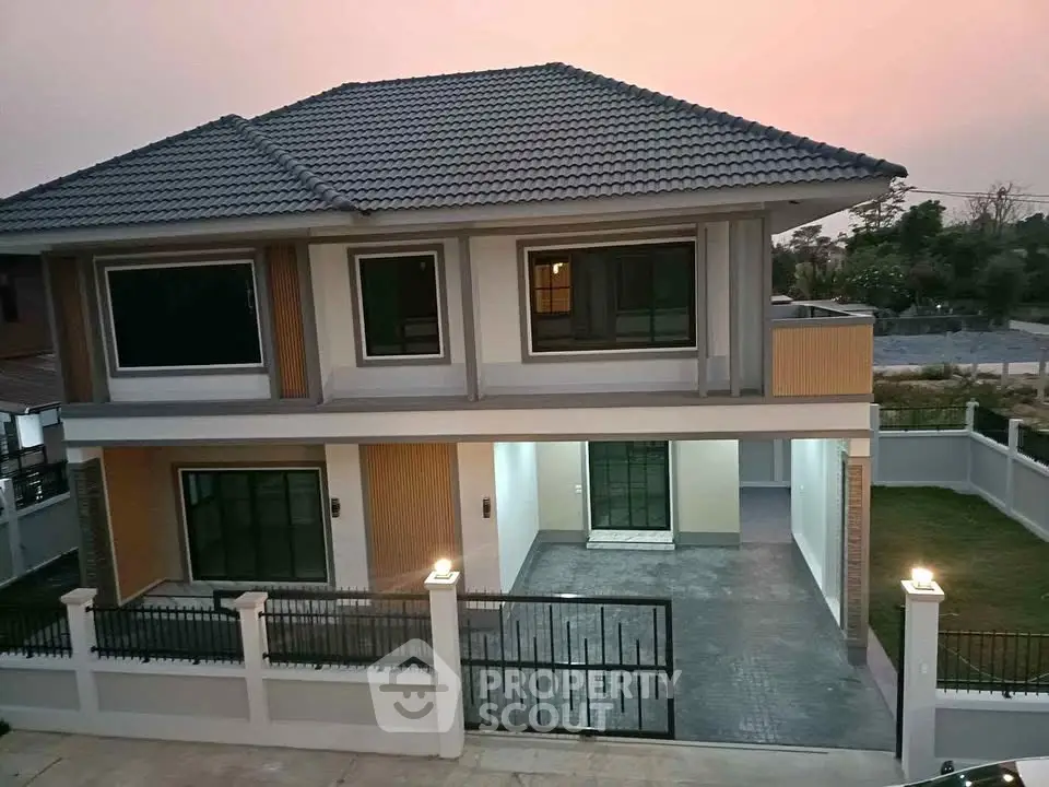 Modern two-story house with spacious driveway and elegant exterior design at sunset.