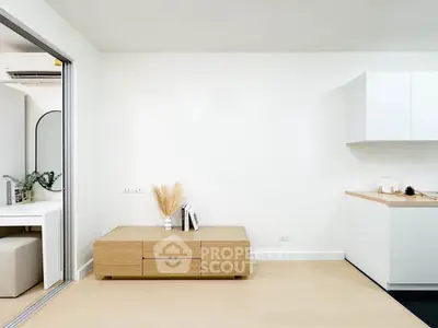 Modern minimalist living space with sleek kitchen and stylish decor