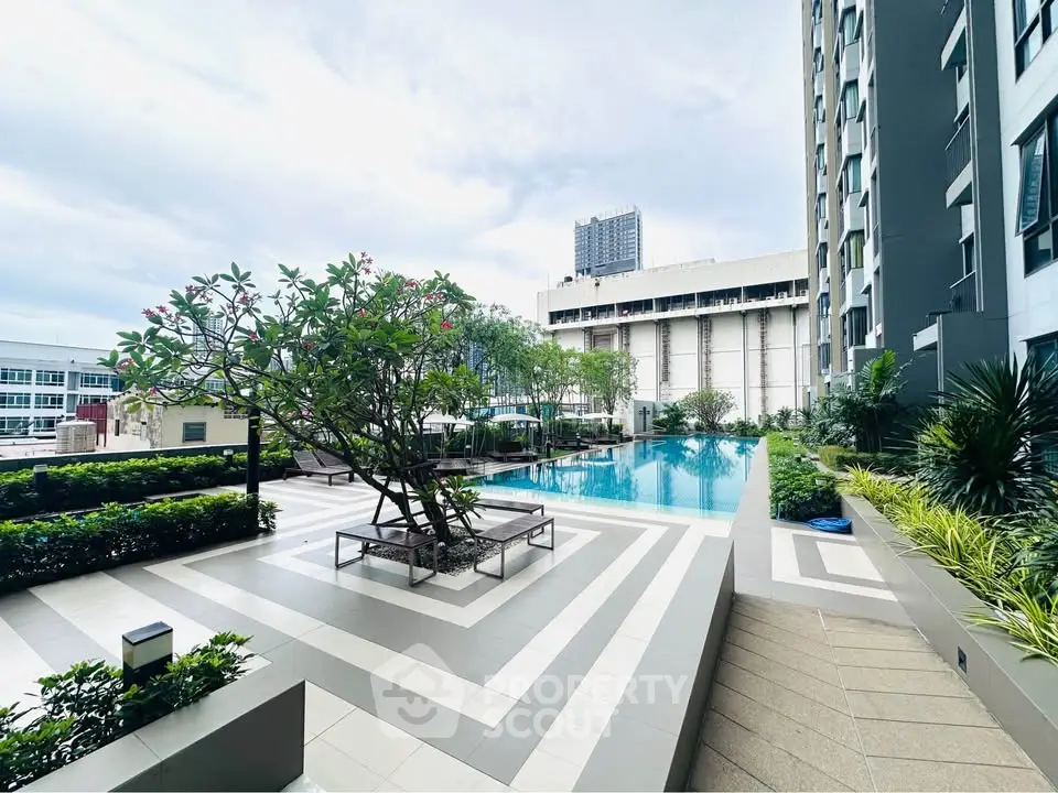 Luxurious apartment complex with a stunning outdoor pool and lush greenery, perfect for relaxation and leisure.