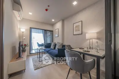 Modern living room with stylish decor and balcony access in a contemporary apartment.