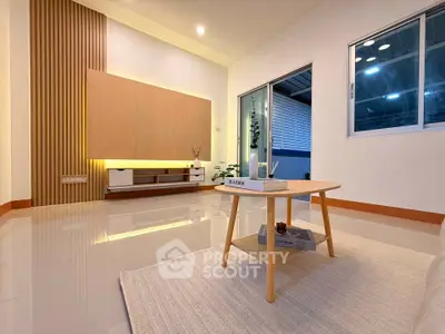Modern living room with sleek design and cozy ambiance, featuring a stylish coffee table and elegant lighting.