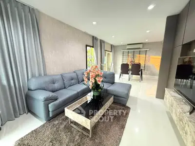 Spacious modern living room with elegant decor and open dining area