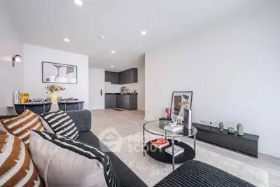 Modern living room with stylish decor and open kitchen layout in a contemporary apartment.