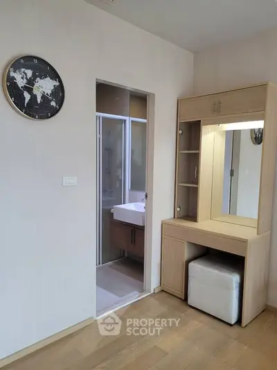 Modern bedroom with vanity and ensuite bathroom in stylish apartment