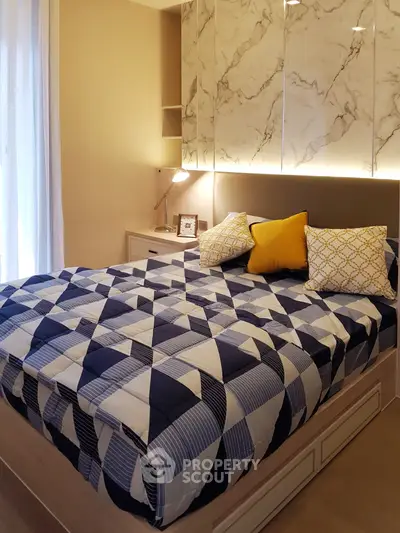 Cozy bedroom with modern decor and stylish bedding in a well-lit space.