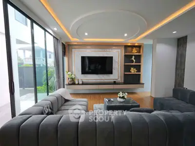 Luxurious modern living room with sleek design and large windows offering natural light.