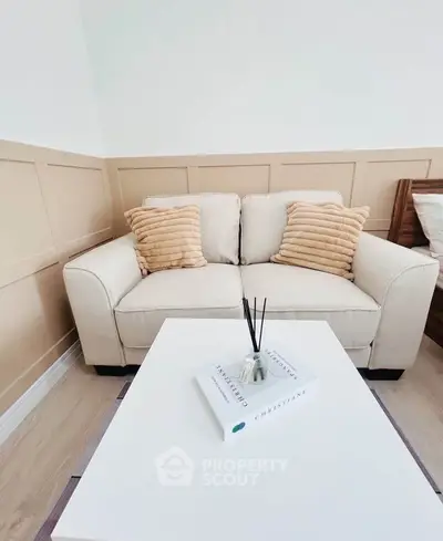 Cozy living room with beige sofa and stylish decor in modern apartment.
