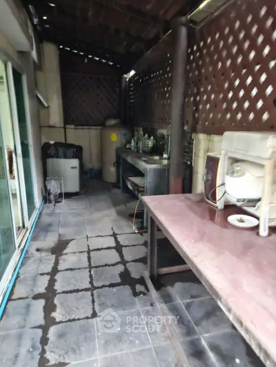 Outdoor utility area with tiled flooring and storage space