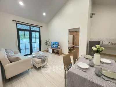 Spacious modern living room with dining area and large windows, perfect for family gatherings.