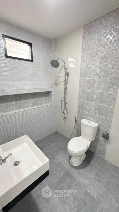 Modern bathroom with sleek gray tiles and contemporary fixtures
