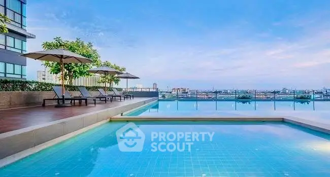 Luxurious rooftop pool with stunning city views and modern lounge area.
