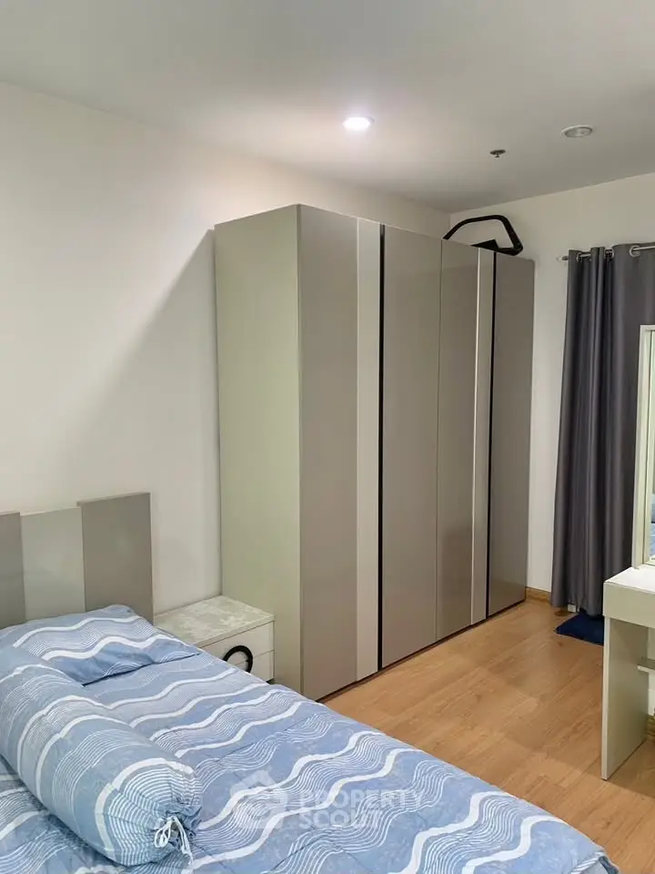 Modern bedroom with sleek wardrobe and cozy bed in stylish apartment.
