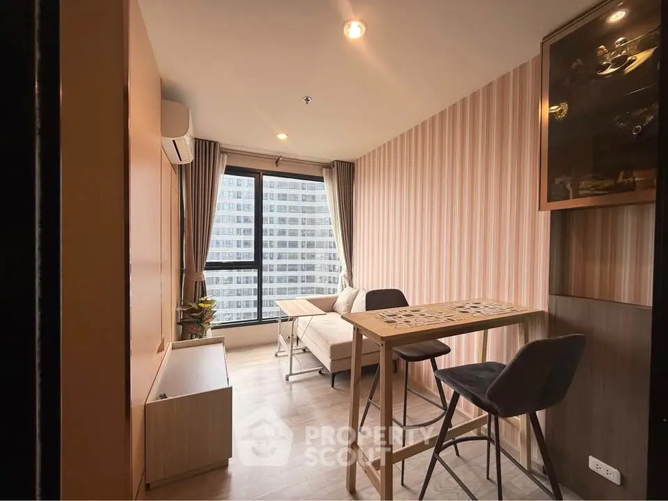 Modern living room with stylish decor and city view, featuring a cozy seating area and dining space.