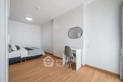 Modern minimalist bedroom with wooden flooring and study desk