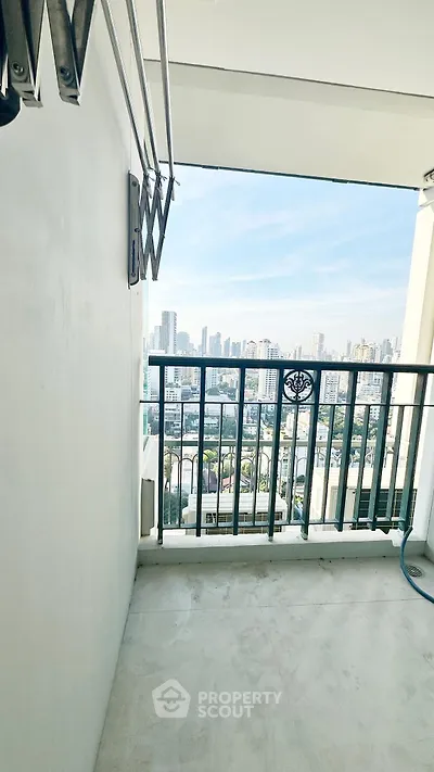 Spacious balcony with stunning city skyline view, perfect for relaxation and enjoying urban living.