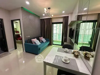 Modern living room with stylish decor and balcony view in a contemporary apartment.