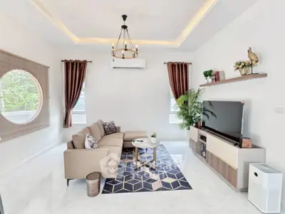 Elegant living room with modern decor, cozy sofa, and stylish chandelier.
