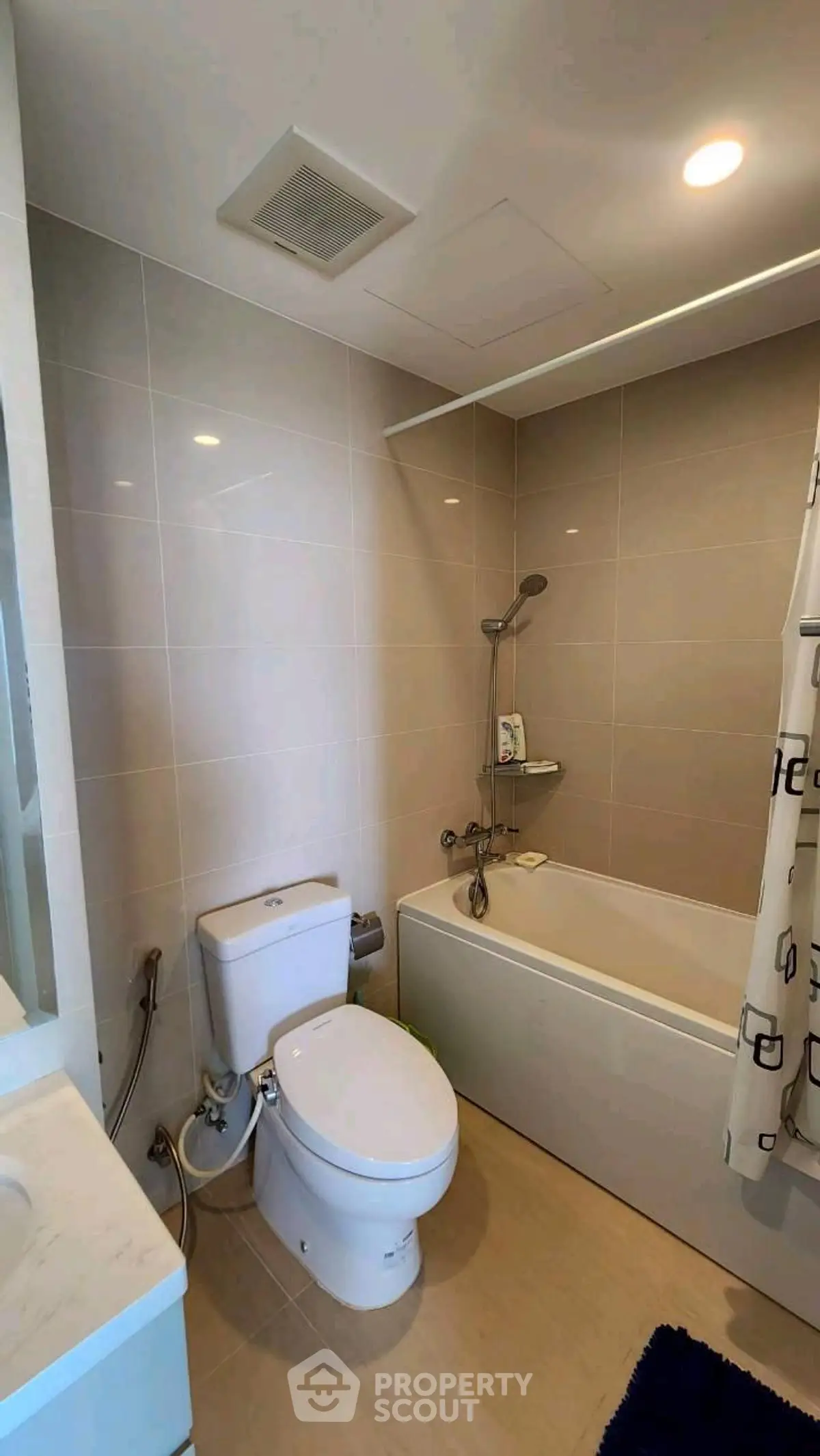 Modern bathroom with bathtub and shower in sleek apartment