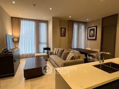 Modern living room with elegant decor and open layout, featuring a cozy sofa and stylish dining area.