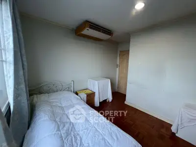 Cozy bedroom with single bed and air conditioning, perfect for a peaceful retreat.