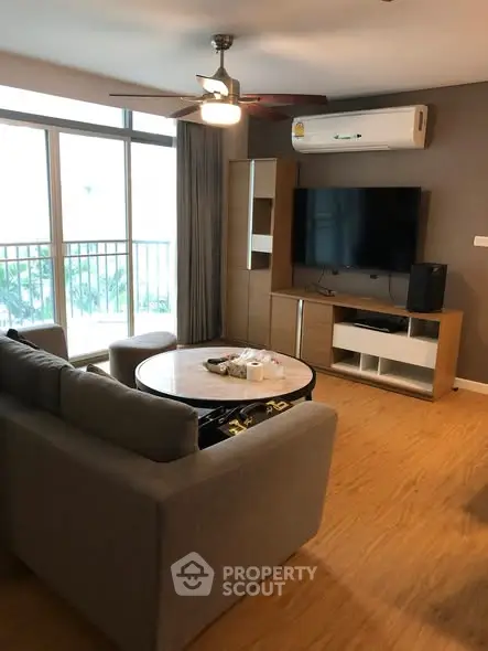 Spacious living room with modern furniture and large window view