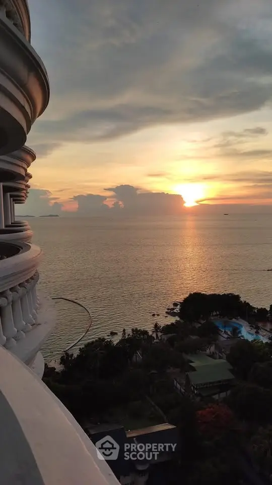 Stunning ocean view from a high-rise balcony at sunset, perfect for luxury living.