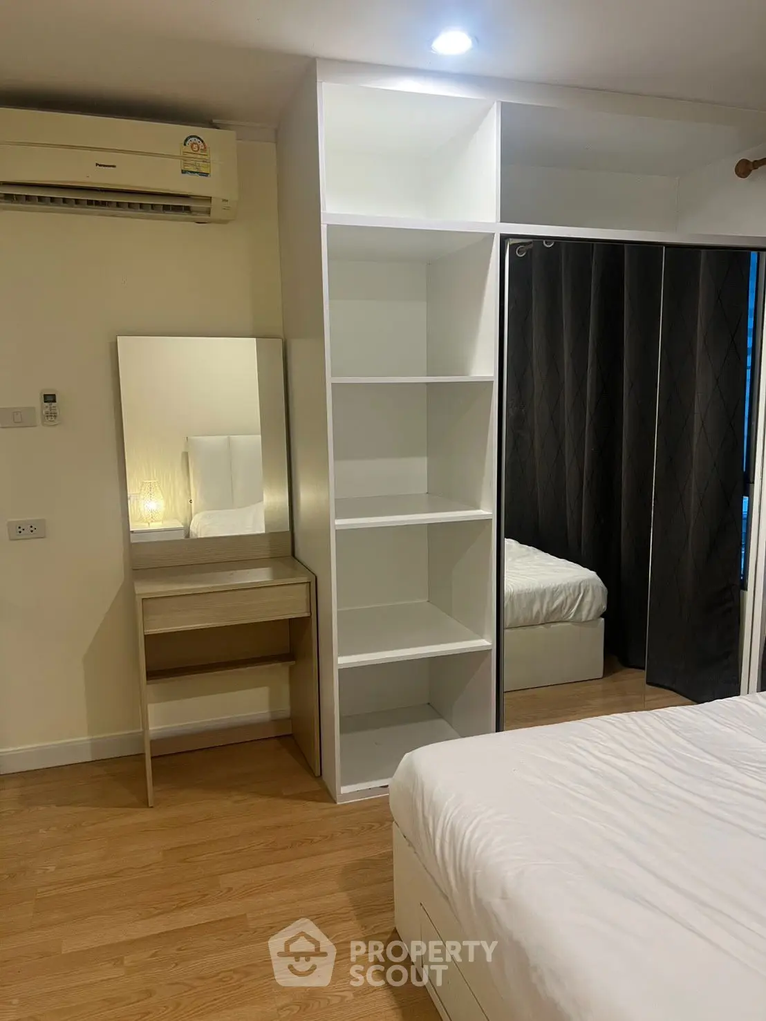 Modern bedroom with built-in wardrobe and vanity mirror