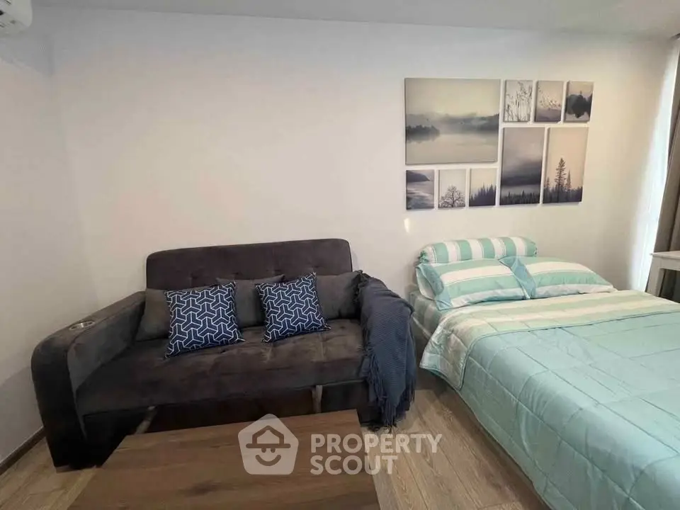 Cozy living room with stylish sofa and bed, perfect for modern urban living.