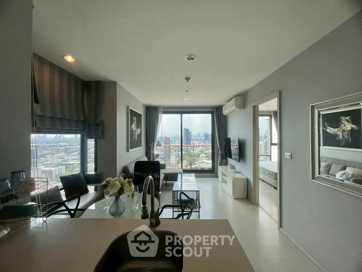 Modern open-plan living room with stunning city view and elegant decor