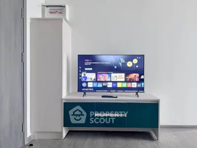 Modern living room with sleek TV stand and flat-screen TV, perfect for entertainment and relaxation.