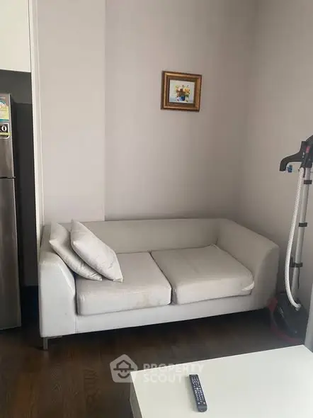 Cozy living room with modern white sofa and sleek decor, perfect for relaxation.