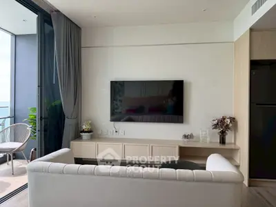 Modern living room with sleek TV setup and balcony view