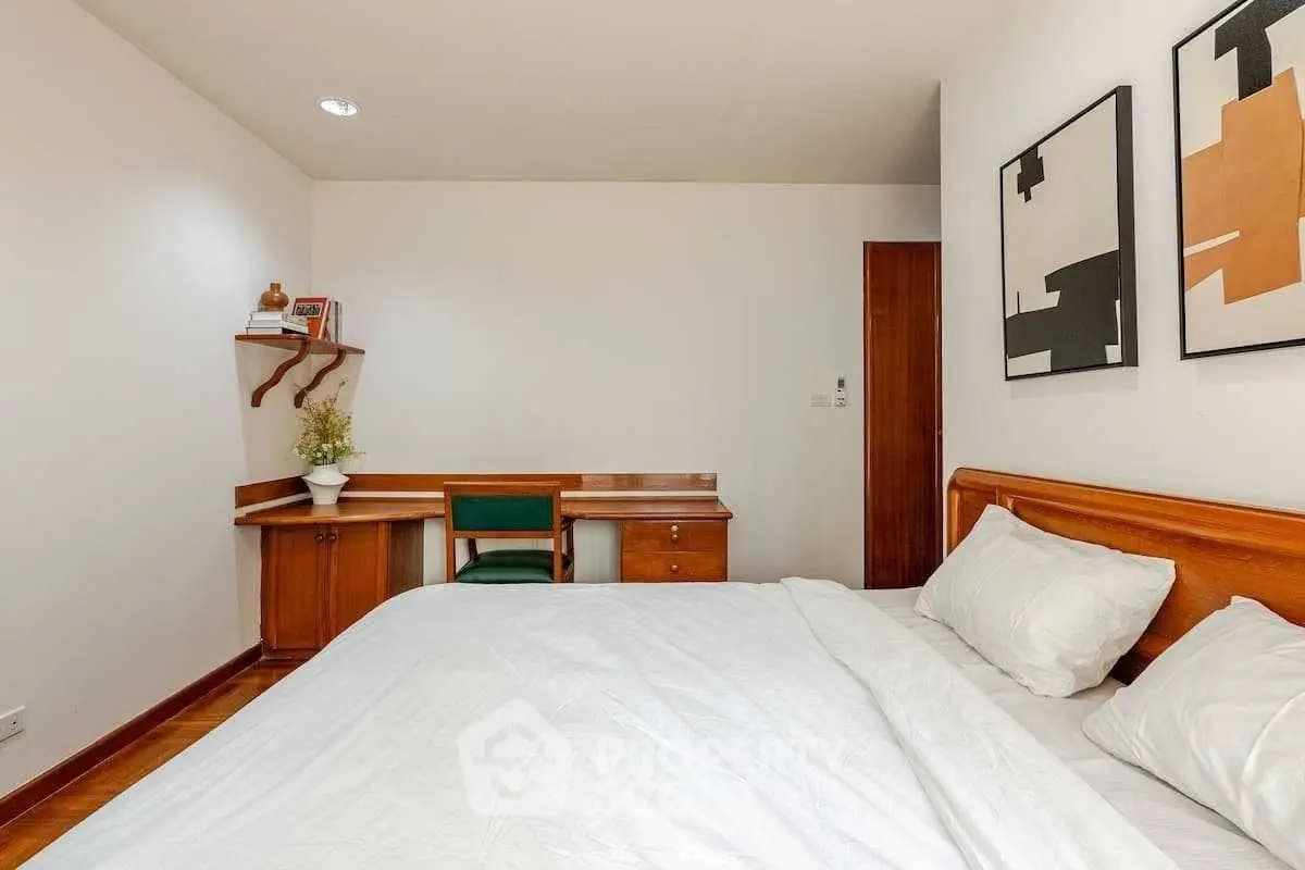 Cozy bedroom with wooden furniture and modern art decor