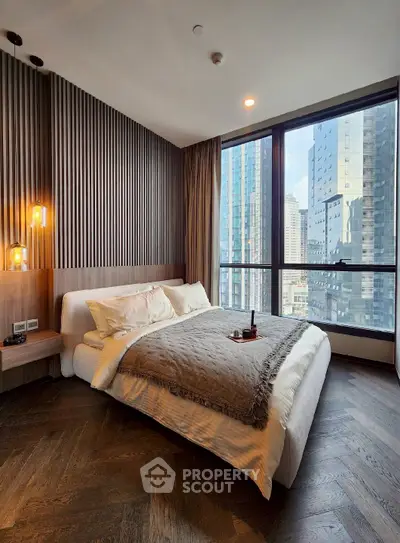 Luxurious bedroom with stunning city view and modern decor in high-rise apartment.