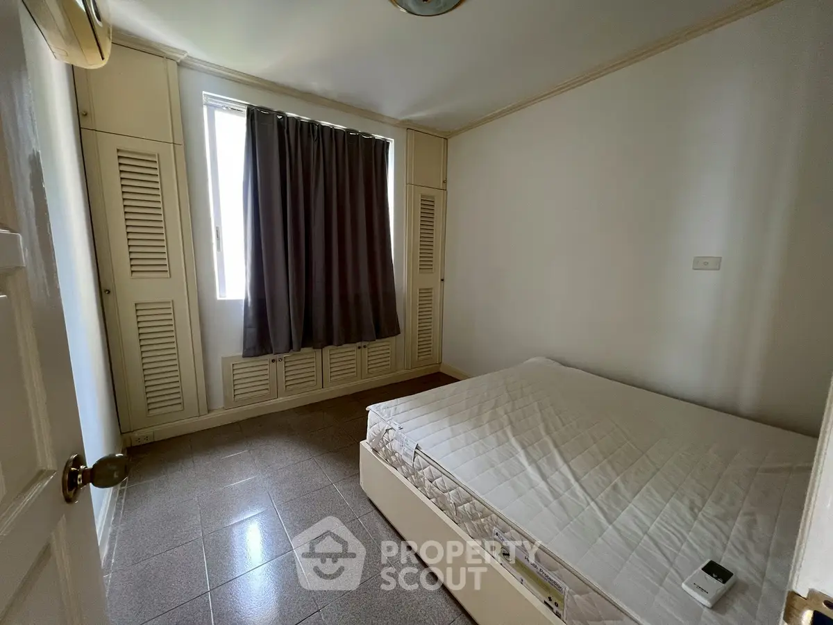 Cozy bedroom with natural light and minimalist design, perfect for relaxation.