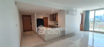 Modern open-layout kitchen with sleek design and balcony view in urban apartment