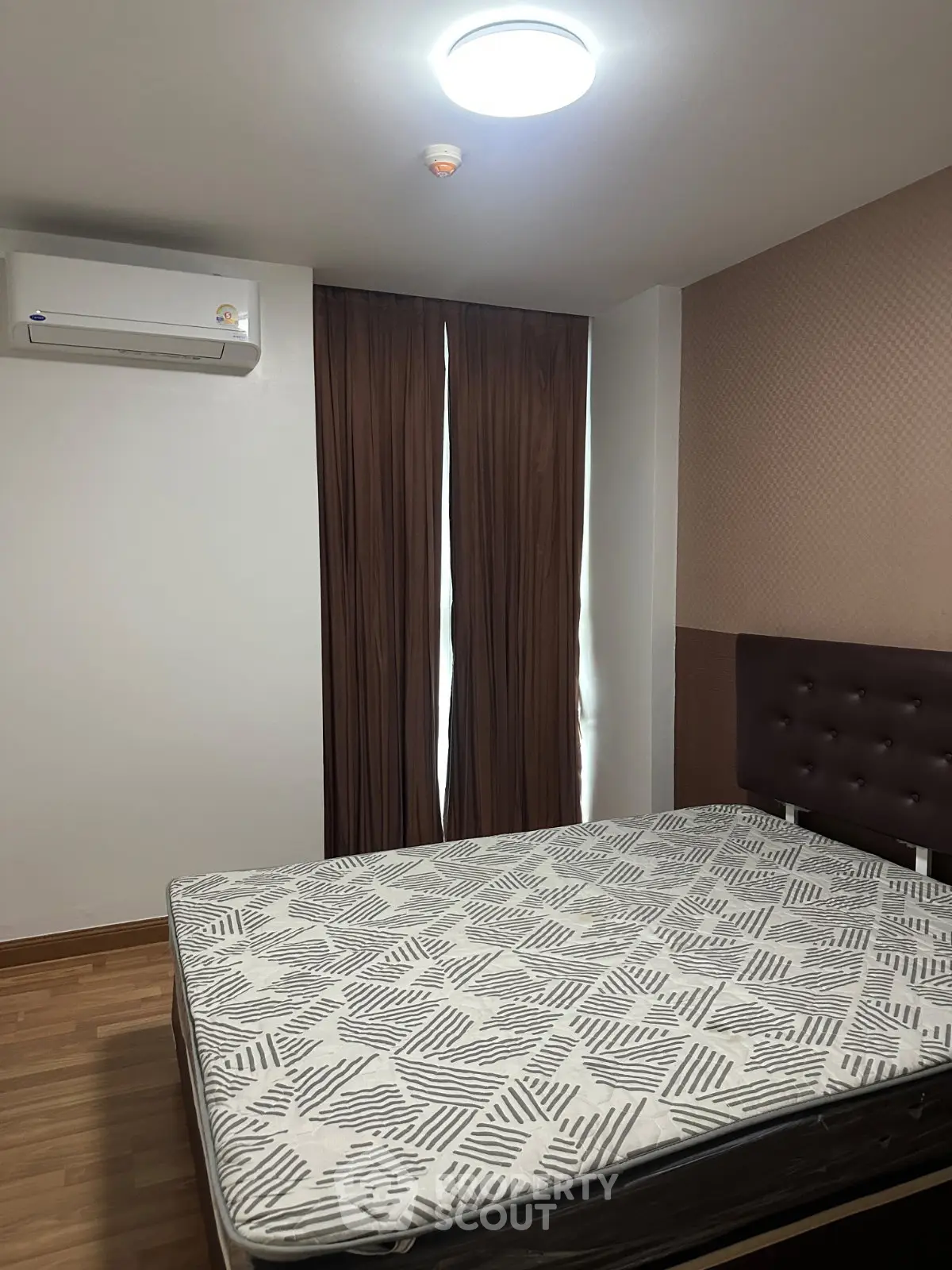 Modern bedroom with air conditioning and stylish decor in a real estate property.