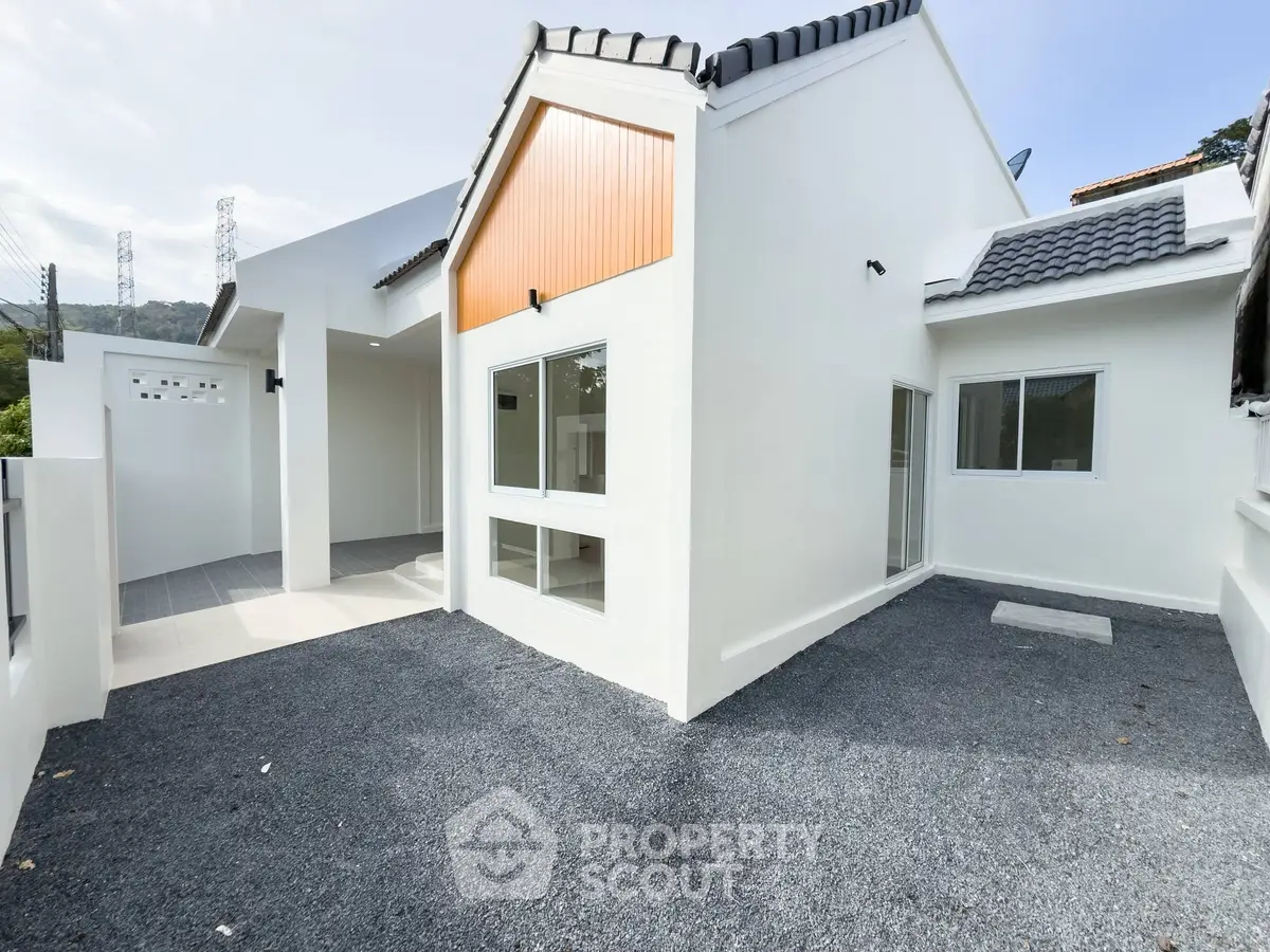 Modern white house exterior with sleek design and spacious driveway