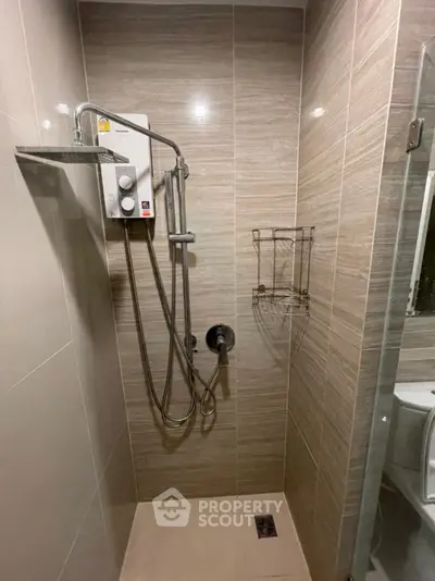Modern bathroom with sleek shower fixtures and neutral tile design
