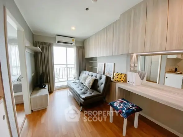 Modern living room with stylish decor and balcony view in a cozy apartment.