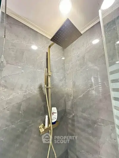 Luxurious modern shower with sleek fixtures and elegant marble tiles.